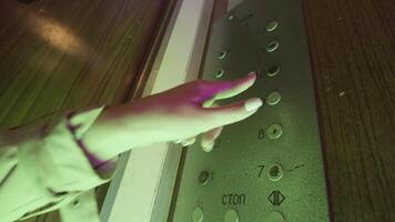 Close up of a drunk female hand pressing all the buttons inside an old elevator with flashing lights. Stock footage. Dangerous use of the elevator under the influence of alcohol or drugs. video