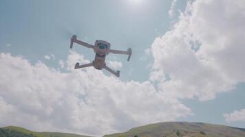 Quadcopter flying on background of mountains and sky. Action. Professional quadcopter for shooting while traveling. Quadcopter rises and takes pictures of mountain landscapes video