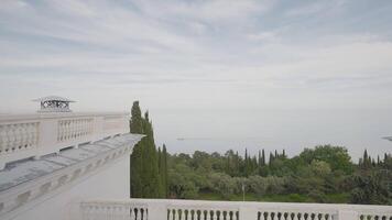 View from hotel's balcony to sea. Action. Roof of old hotel with columns on background of sea. View of sea and vegetation from roof of hotel video