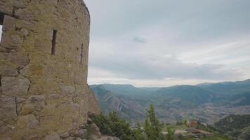 Stone walls of ruins of old city. Action. Historical ruins of old stone town in mountains. Abandoned stone city on background of mountain landscape video