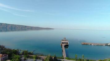 Abandoned coastal village. Shot. Top view of abandoned fishing village on coast of blue sea. Abandoned factory on coast of blue lagoon in Crimea video