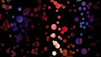 Colorful circles falling down on a black background, seamless loop. Motion. Polka dot pattern of small circular shapes moving from top to bottom. video