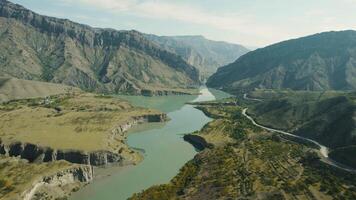 Beautiful valley with mountain quiet river and rocks. Action. Amazing relief of mountain valley with dirty river. Top view of beautiful river and rocky mountains in distance video