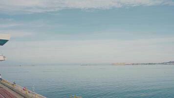 Beautiful seascape with smooth blue water on sunny day. Action. Coast with calm blue water during day. Blue water on background of coast on horizon video