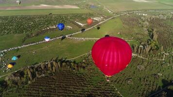 Aerial panoramic view of hot air balloons flight above summer green natural landscape. Shot. Exploring the beauty of nature above fields. video
