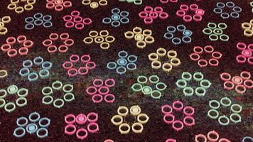 Floral abstract background with children small flowers formed by neon colorful circles, seamless loop. Animation. Art kaleidoscopic pattern with round shapes forming figures. video