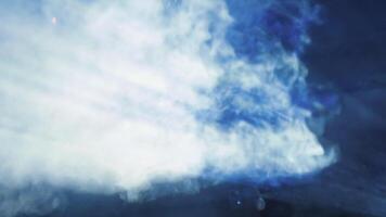Smoke . Clip. Puffs of steam fluttering against the backlit dark background. video
