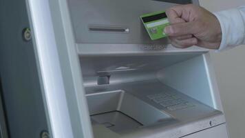 Male hand attaching the card to the ATM machine, withdrawing money from account. HDR. Automatic machine for cash withdrawal. video