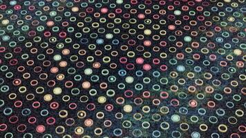 Moving surface with many small round shaped silhouettes and colorful blinking circles inside them, seamless loop. Animation. Light flares flowing all over the black screen, concept of energy. video