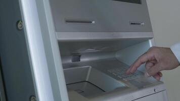 Male hand entering pin code on ATM keyboard, withdrawing money from account. HDR. Automatic machine for cash withdrawal. video