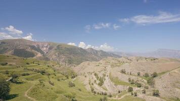 Aerial view of amazing landscape with beautiful valley on a sunny day. Action. Flying above summer mountains on blue cloudy sky background. video