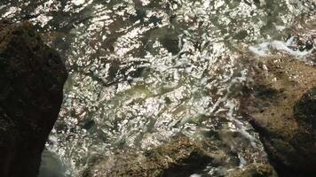 The river bank. Creative . Clear river water beating against the rocks on the shore video