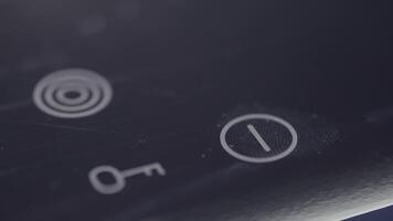 Person using touch controls on a modern glass topped hob to switch on an electric hotplate. Action. Close up of turning on the induction hob. video