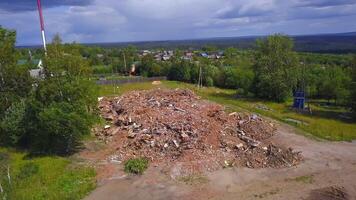 View from the height . Clip. A broken building next to a park and houses and a forest. video