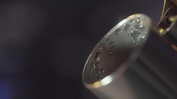 Extreme close up of steel kettle spout with drops of water on its surface. Action. Steam coming from the kettle spout on blurred background. video