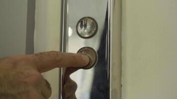 Man finger reaches in and presses elevator button which lights up. HDR. Close up of metal buttons of a public elevator. video