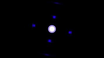 Abstract spinning colorful wheel silhouette on a black background, seamless loop. Design. Blue rotating circle with lights around the central point. video