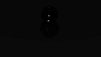 Tiny light particles rising up in the dark. Design. Small flying white dots on a black background, seamless loop, monochrome. video