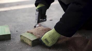 Laying the floor. Clip. A man makes a special fiber for insulation of floors in houses with a stapler. video