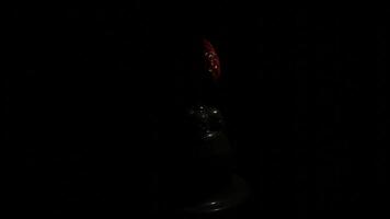 Abstract piece of art isolated on a black background under the spotlight changed by shadow. Design. Red gemstone egg at the exhibition. video