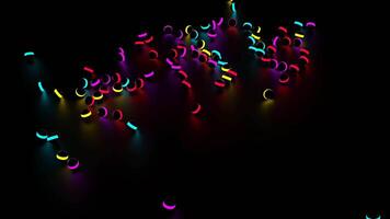 Many small dark balls with colorful neon stripe falling down and rolling into all the sides. Design. Small spheres with bright glowing lines isolated on a black background. video