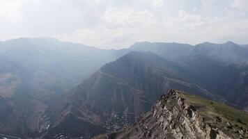 Aerial view over stunning natural landscape with summer huge rock formations. Action. Flying above green slopes covered by grass and trees. video