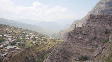 Aerial view of the ancient abandoned destroyed city. Action. Flying above old stone buildings built on the slope of a mountain. video