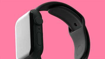 Close up of a new smart watch model with touch screen isolated on a pink background. Motion. Modern technological device in slow motion. video