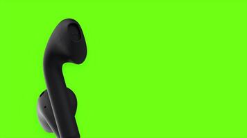 Green background. Motion. Black wireless headphones move in abstraction on a bright background. video