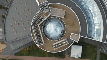 Top view of roof of modern building with glass dome. Stock footage. Beautiful modern building with glass dome on roof. Glass dome on roof of large building video