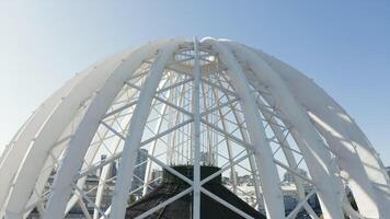 Modern white dome-shaped structure. Stock footage. Top view of beautiful domed structure in modern city. Beautiful domed structure with white body video