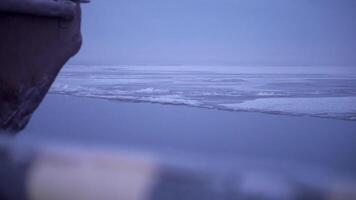 Ship sailing on icy lake. Clip. Sea route on icy lake on winter day. Beautiful view from deck of ship to sea horizon in winter video