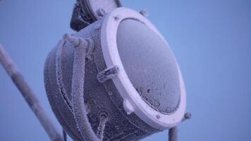 A bright frozen lantern.Clip. Blue sky and a bright big lantern that was covered with ice from the cold and a bright sky. video