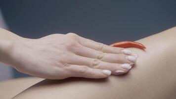 Massage with Thai pepper. Action. The body that is massaged with the help of hot red pepper and slimming cream. video