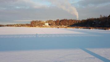 The sun has just risen and lights up a frozen lake in Scandinavia video