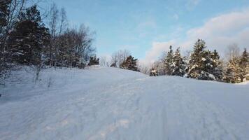 The sun has just risen in a cloudy sky over the snowy hill in Scandinavia video