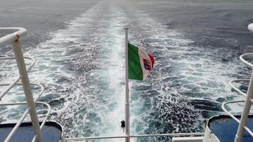 4K of the Italian flag waving at the stern of a moving ferry video