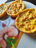 a plate with three small food items on it photo