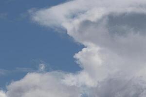 Cloudscape scenery, overcast weather above dark blue sky. Storm clouds floating in a rainy dull day with natural light. White and grey scenic environment background. Nature view. photo