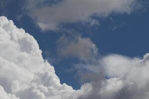 Cloudscape scenery, overcast weather above dark blue sky. Storm clouds floating in a rainy dull day with natural light. White and grey scenic environment background. Nature view. photo