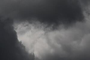 Cloudscape scenery, overcast weather above dark blue sky. Storm clouds floating in a rainy dull day with natural light. White and grey scenic environment background. Nature view. photo