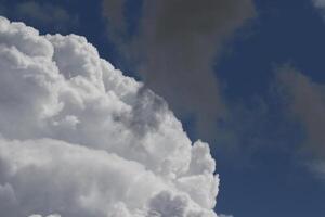 Cloudscape scenery, overcast weather above dark blue sky. Storm clouds floating in a rainy dull day with natural light. White and grey scenic environment background. Nature view. photo