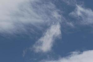 Cloudscape scenery, overcast weather above dark blue sky. Storm clouds floating in a rainy dull day with natural light. White and grey scenic environment background. Nature view. photo