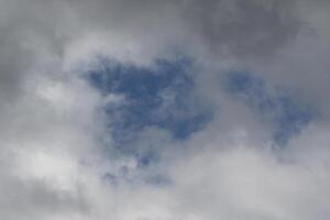 Cloudscape escenario, nublado clima encima oscuro azul cielo. tormenta nubes flotante en un lluvioso aburrido día con natural ligero. blanco y gris escénico ambiente antecedentes. naturaleza vista. foto