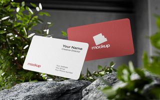 Textured Rounded Business Card Mockup Flying on Top of Rock psd