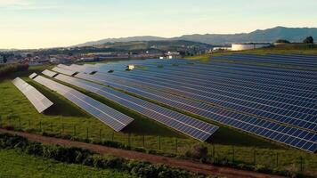 Aerial shot of solar power plant on lush field in village video