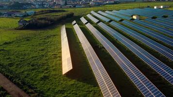 Aerial drone shot of solar panels on lush fields in countryside video