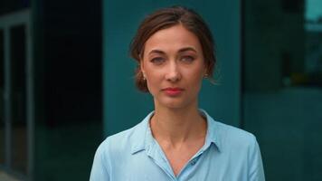 Portrait of confident businesswoman looking at camera outside office video