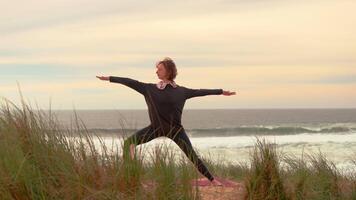 Yoga exercises with autumn ocean view on background video