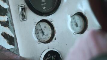 Switches and gauges inside the cabin of an old ship. Clip. Close up of blurred captain hand on wheel and dash board. video